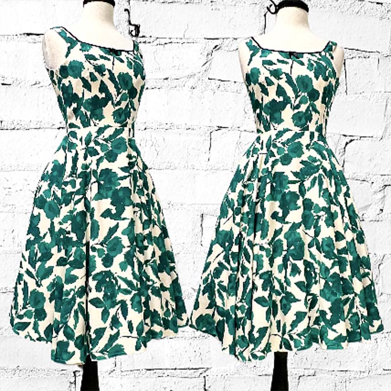 Linen Dress in Green and Ivory floral print.  Princess seamed fitted bodice, back zipper closure, side seam pockets, fit and flare, full lining, and black piping and front bow detail makes for a bit of a contrast.